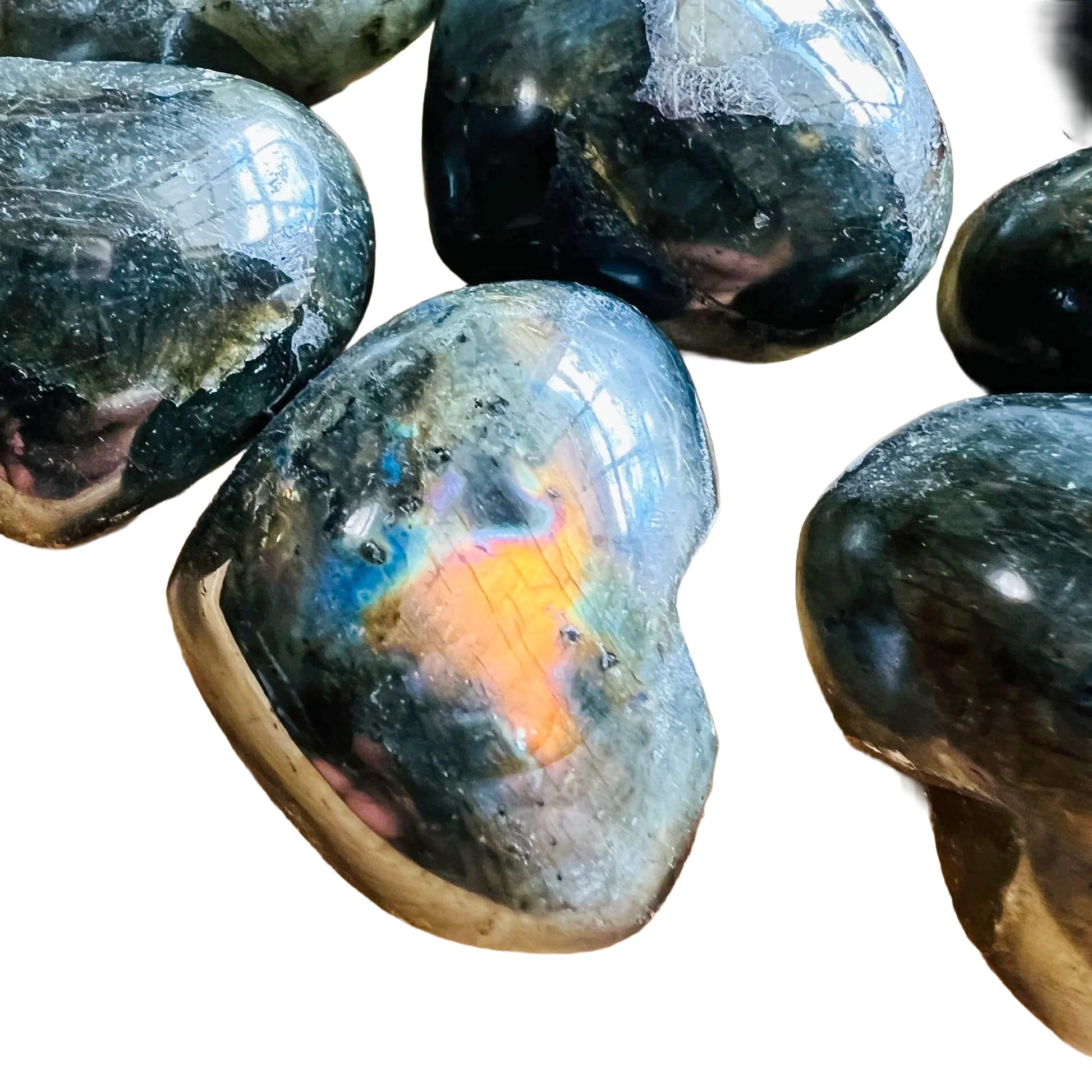 Close detail of Labradorite polished heart, kept near for Intuition, showing earthy tone.