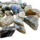 Close-up of Labradorite rainbow raw stones showing blue labradorescence on natural rough surfaces, AA grade