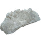 Natural light view of a Clear Quartz specimen held against natural backdrop, sourced from Brazil.