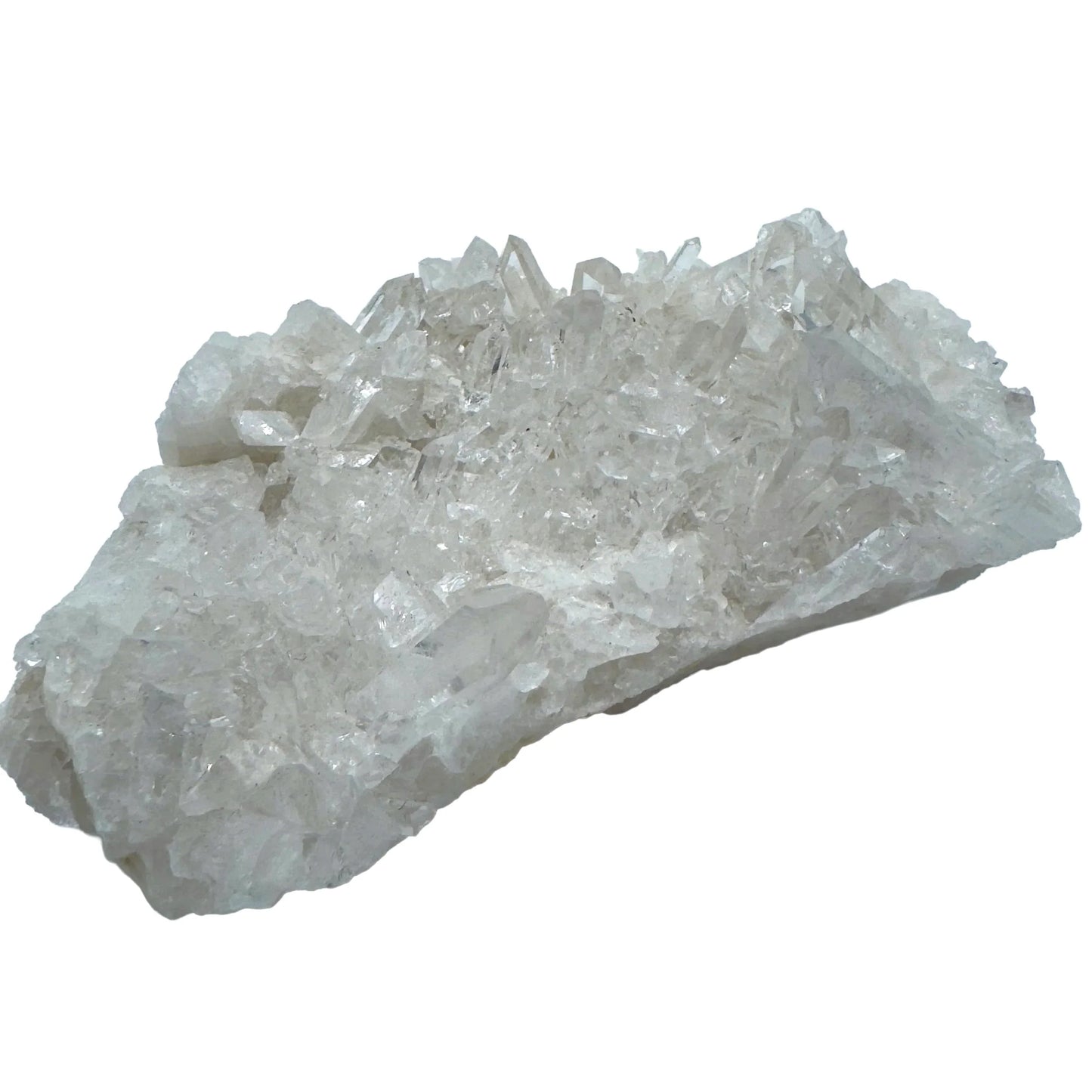 Natural light view of a Clear Quartz specimen held against natural backdrop, sourced from Brazil.