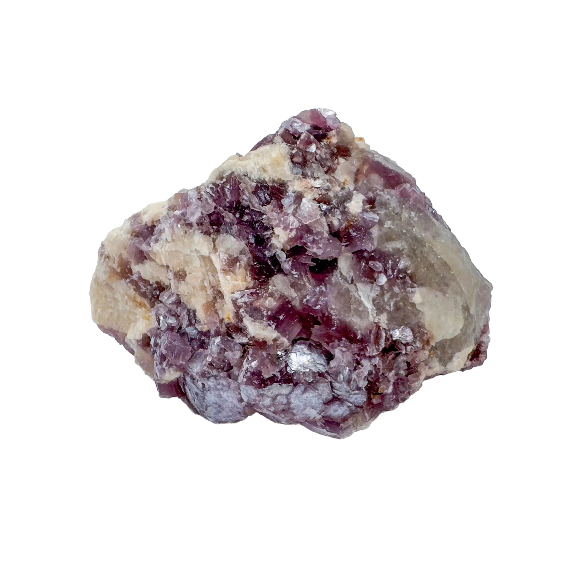 In-hand view of a Lepidolite specimen held against natural backdrop.