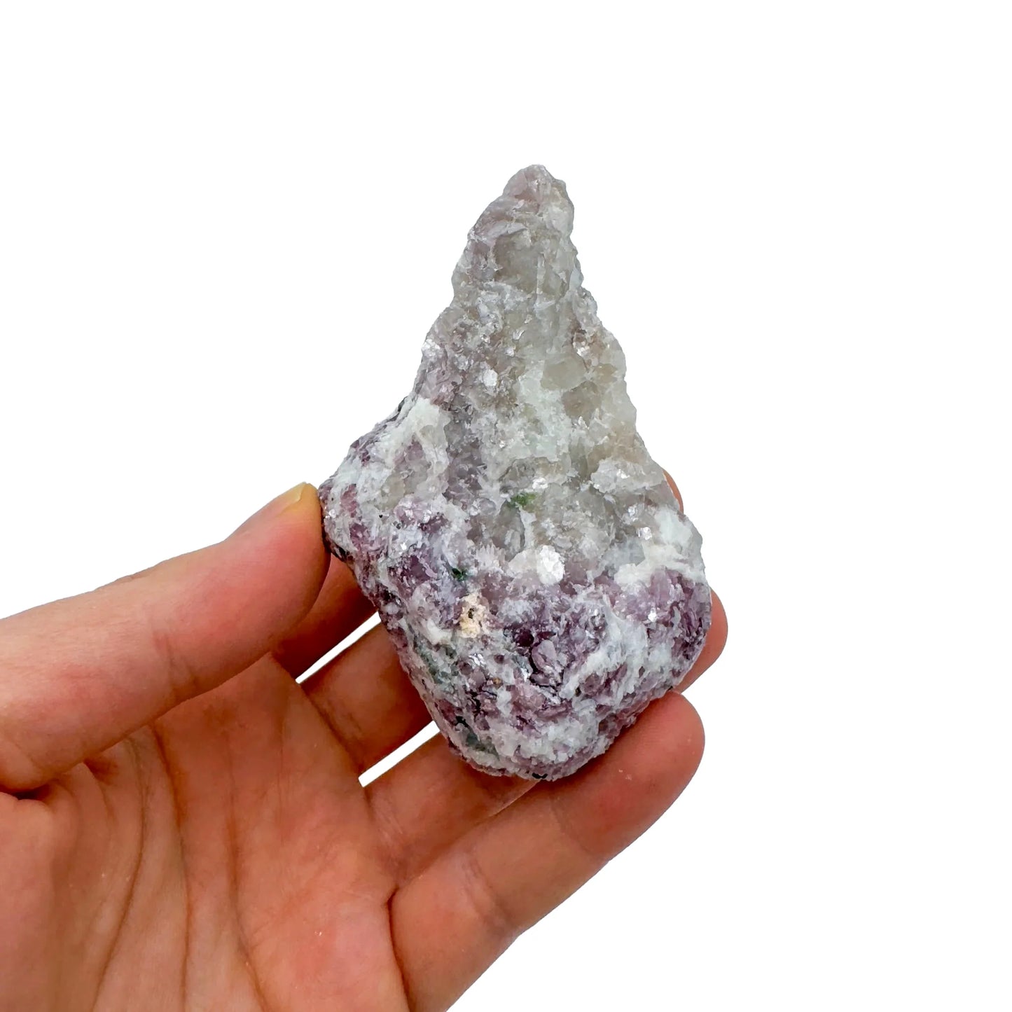 On a soft surface rests a Lepidolite specimen, with surface texture in view.