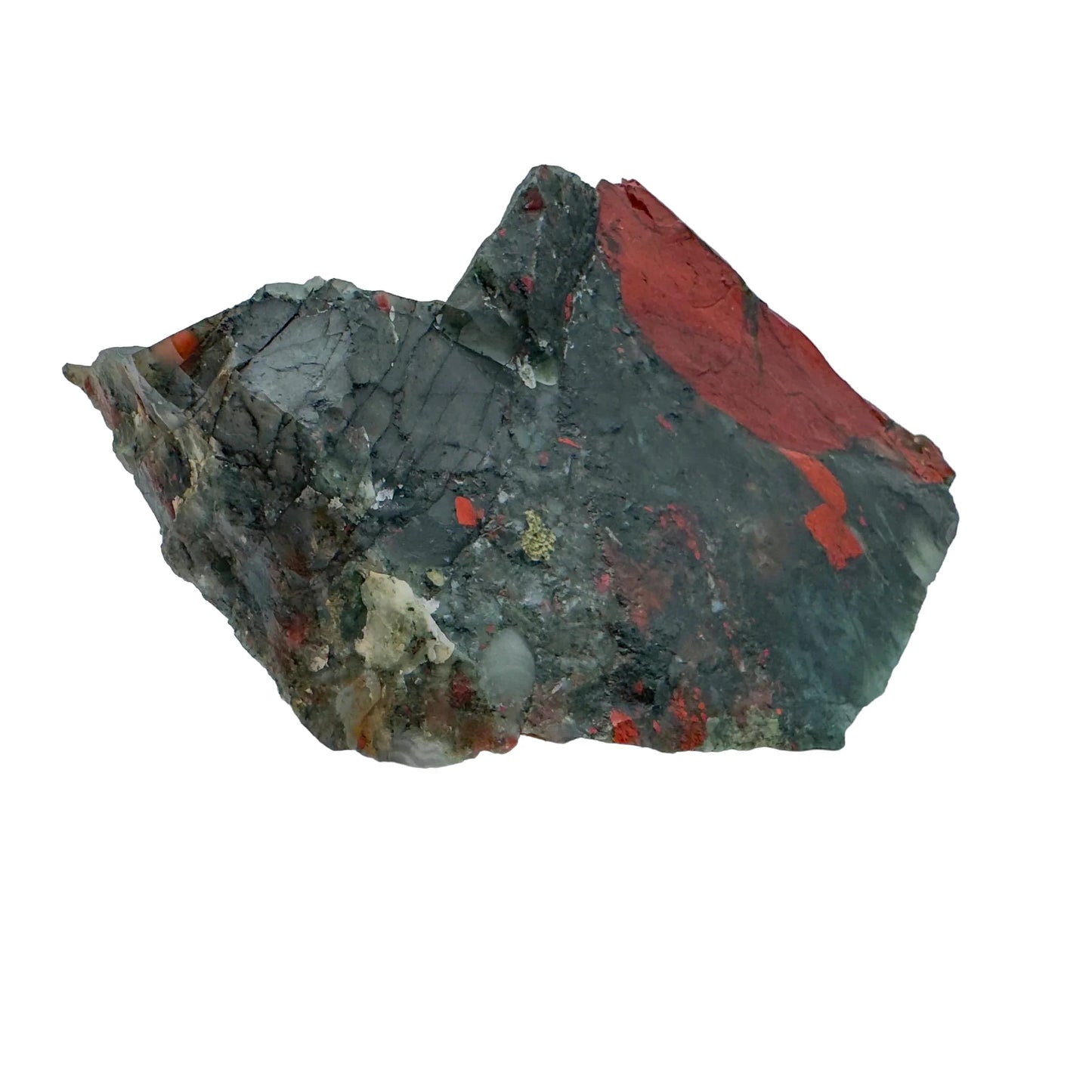 On a soft surface rests a Bloodstone specimen, associated with Grounding, showing natural surface character.