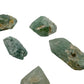 Five chlorite quartz points at 1 to 1.50 inches showing chlorite phantoms and pale matrix on the faces