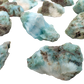 Close view of Larimar raw stones showing sea blue color with white pectolite veining, A grade Dominican Republic