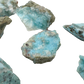 Larimar raw stone detail, jojoba oil finish deepening the natural blue, Barahona Province