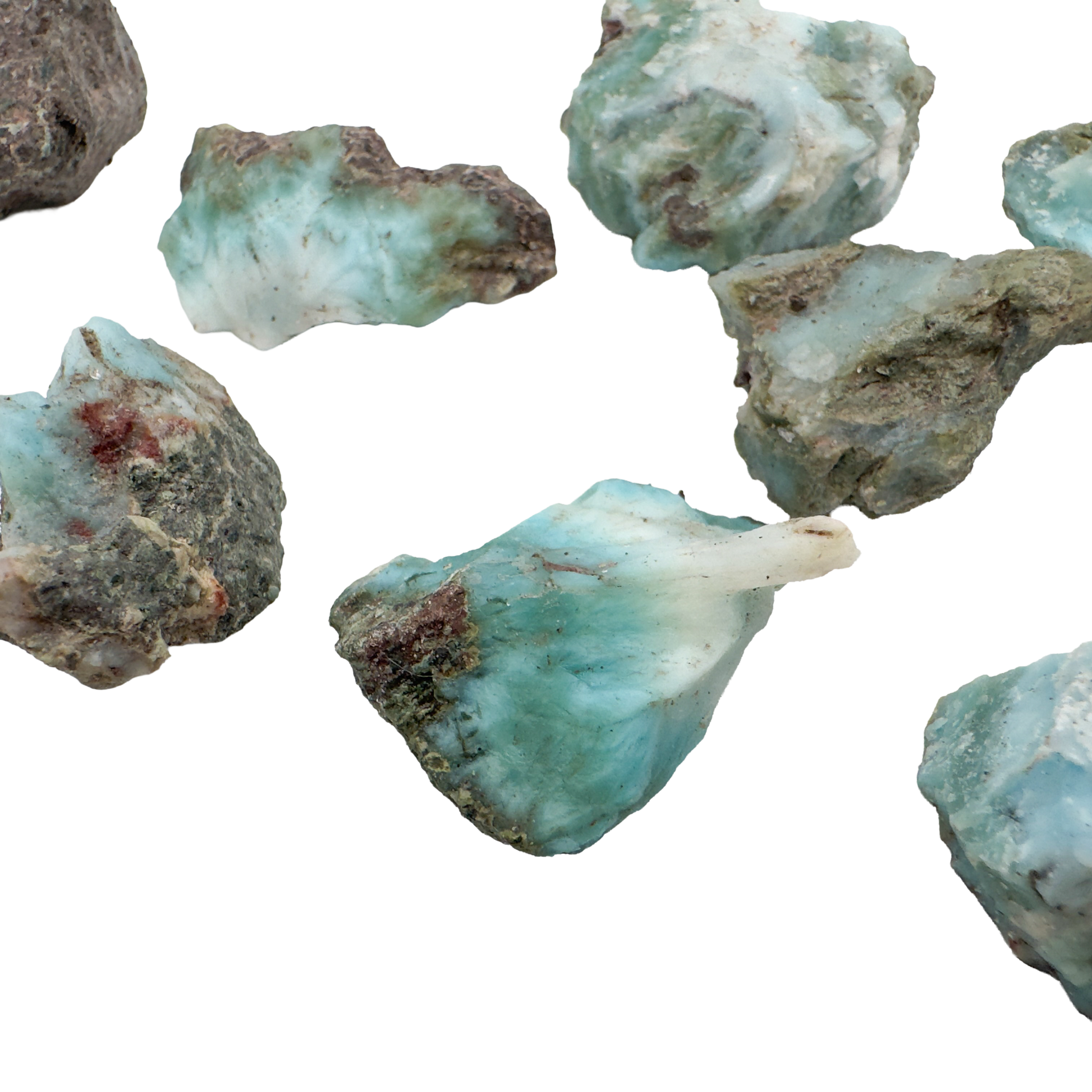 Several Larimar rough pieces showing the range of blue saturation across the batch