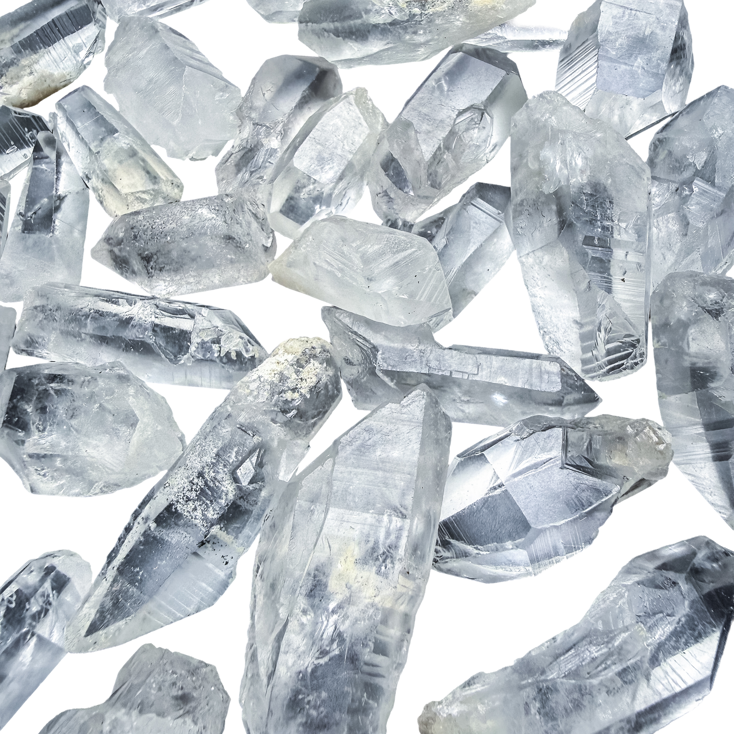 A scatter of A-grade Lemurian Quartz points from Minas Gerais, Brazil, 1 to 2 inches, showing the horizontal ladder striations.