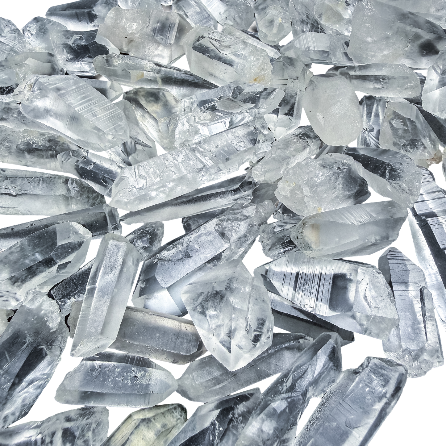 A scatter of A-grade Lemurian Quartz points from Minas Gerais, Brazil, 0.50 to 1.50 inches, showing the horizontal ladder striations.