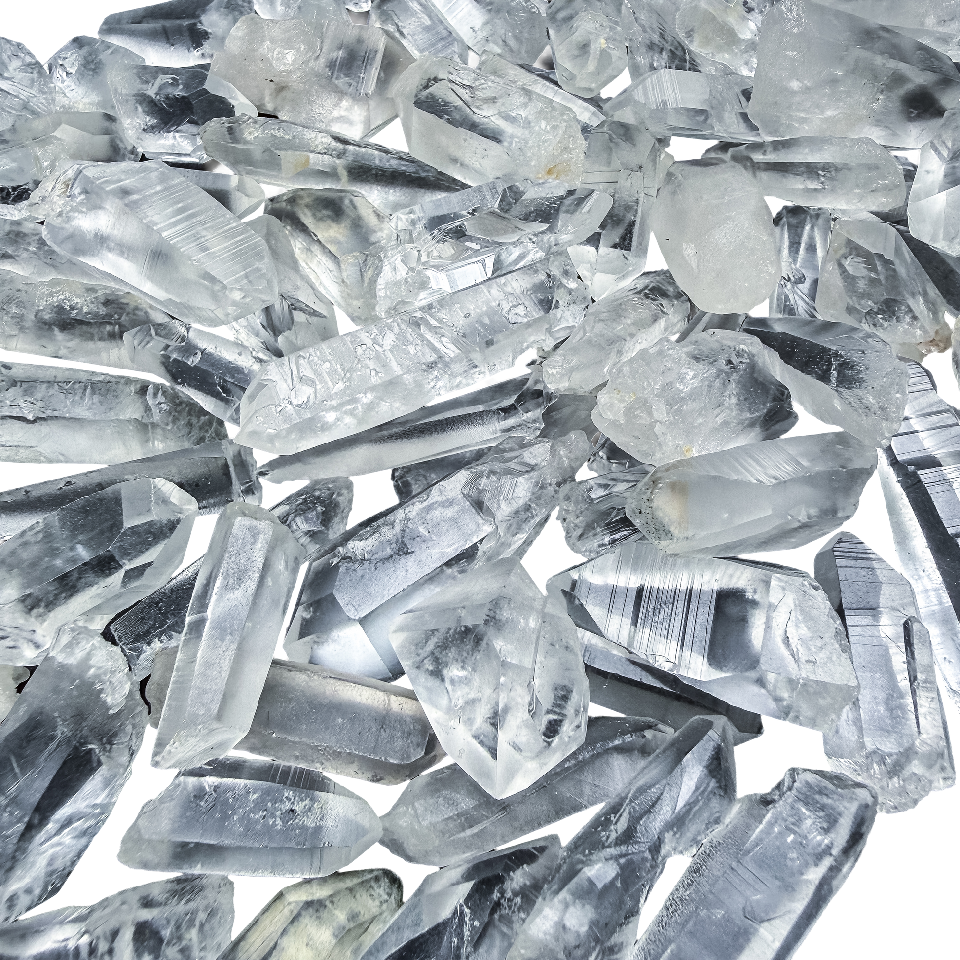 A scatter of A-grade Lemurian Quartz points from Minas Gerais, Brazil, 0.50 to 1.50 inches, showing the horizontal ladder striations.