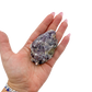 Lepidolite crystal specimen from Brazil held in hand to show scale