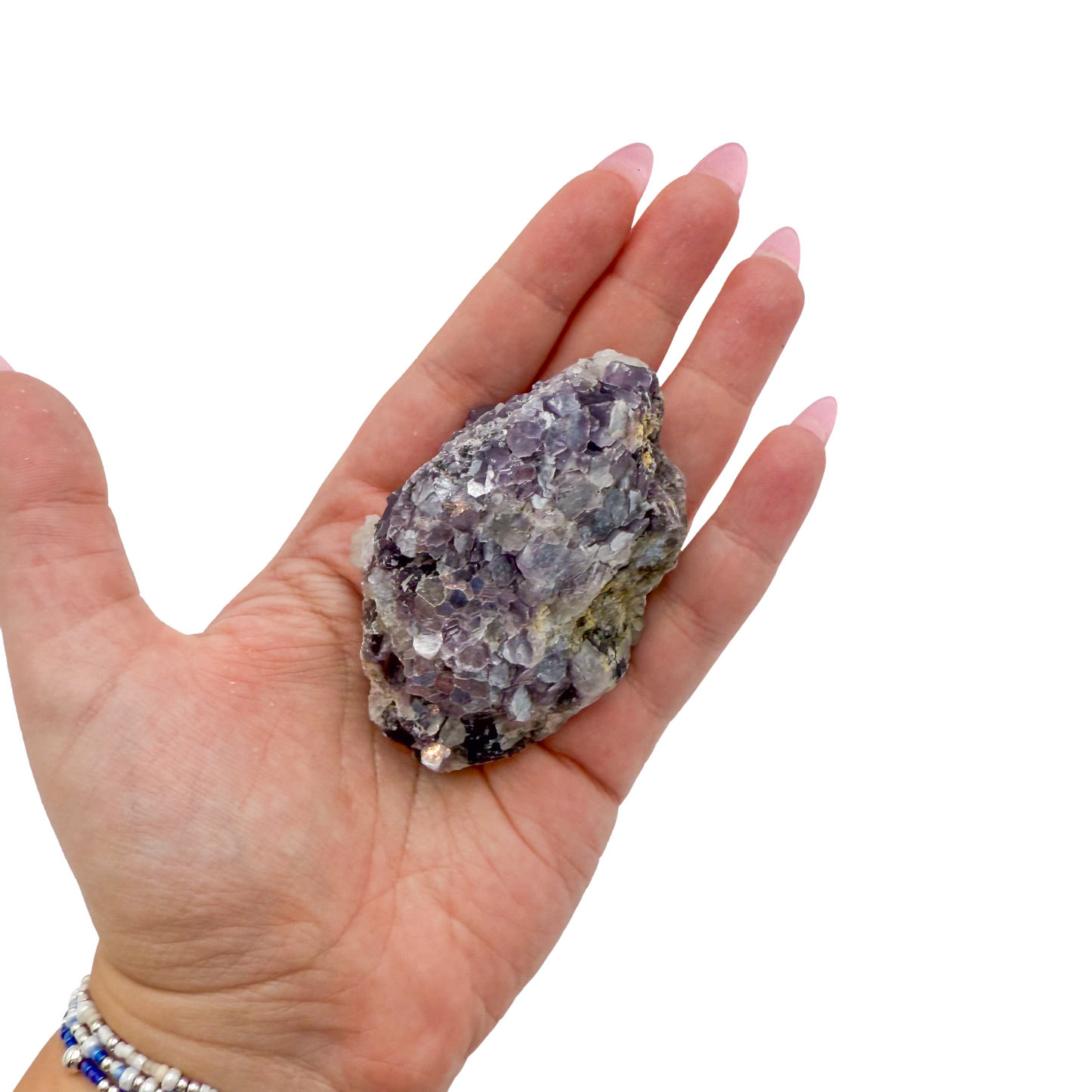 Lepidolite crystal specimen from Brazil held in hand to show scale