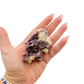 Lepidolite crystal specimen from Brazil held in hand to show scale