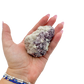 Lepidolite crystal specimen from Brazil held in hand to show scale