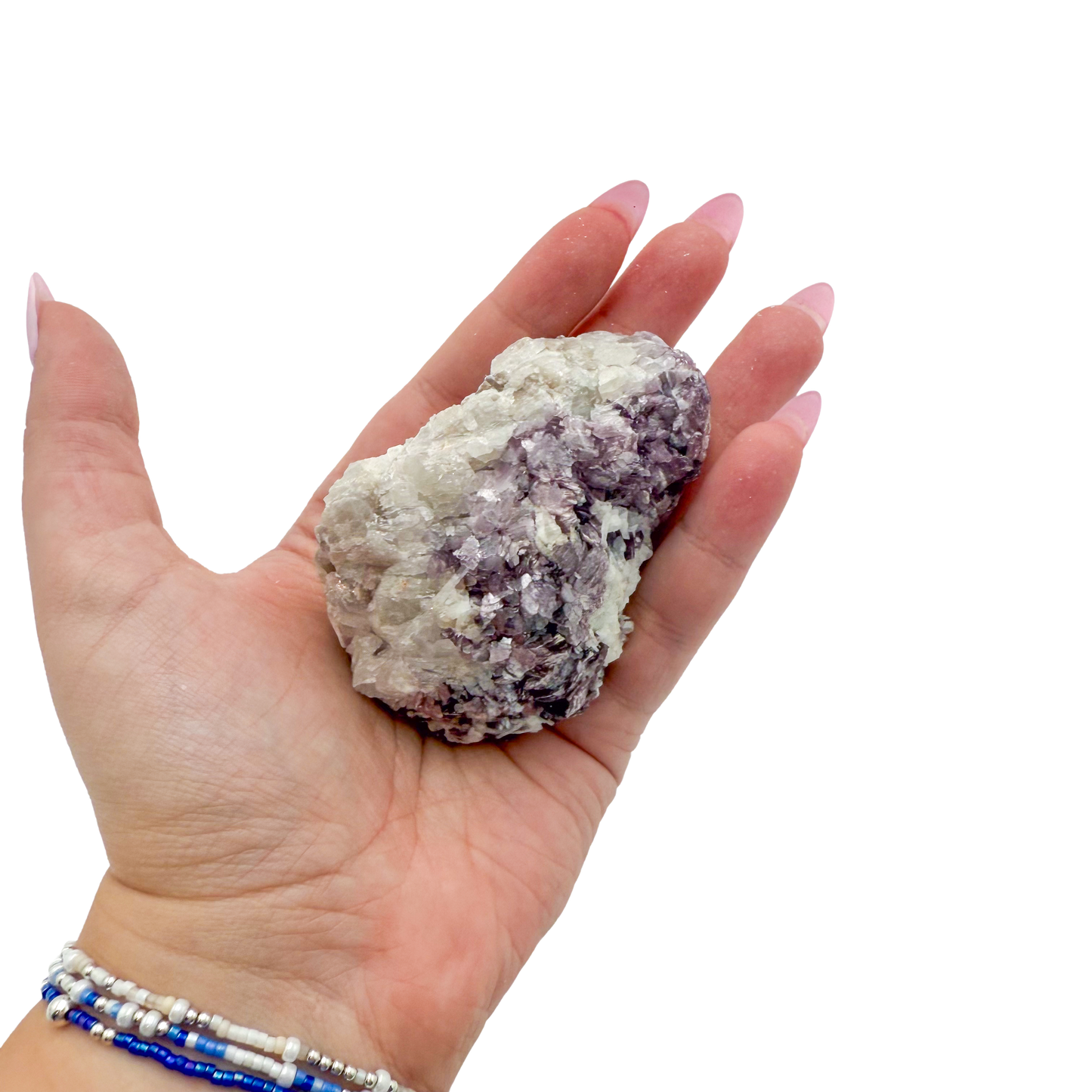 Lepidolite crystal specimen from Brazil held in hand to show scale