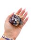 Lepidolite crystal specimen from Brazil held in hand to show scale