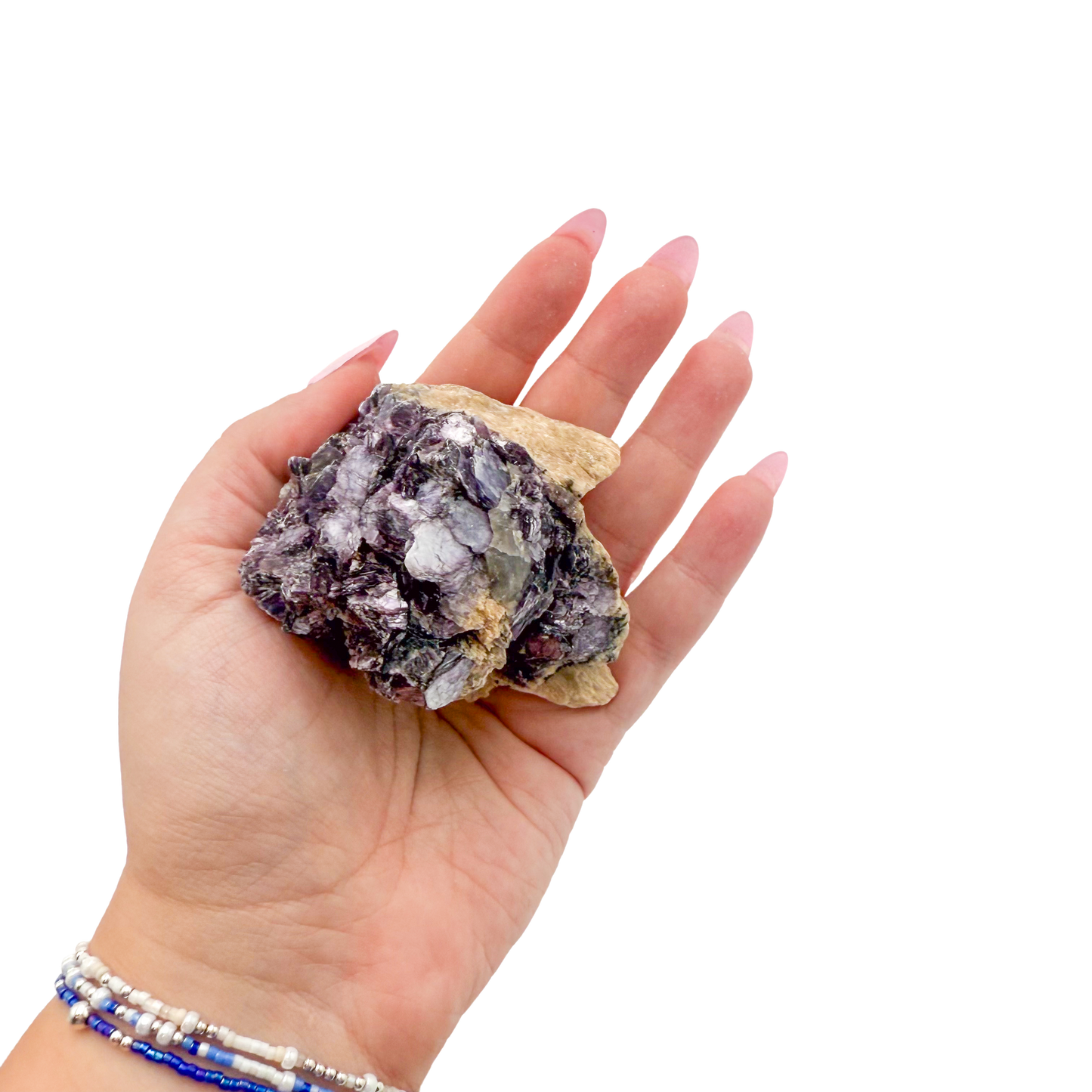 Lepidolite crystal specimen from Brazil held in hand to show scale