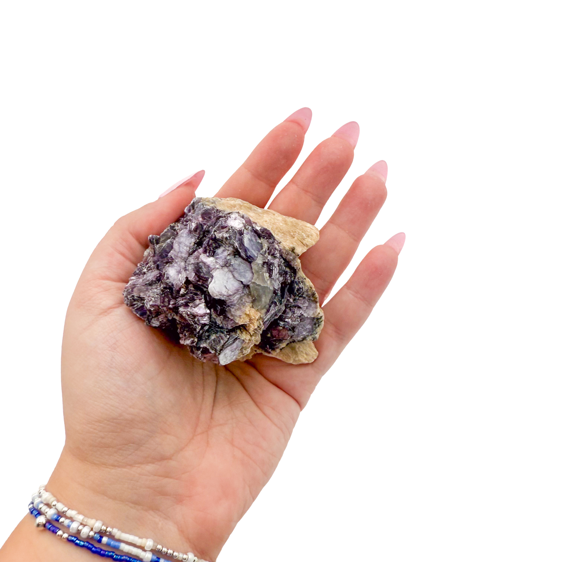 Lepidolite crystal specimen from Brazil held in hand to show scale