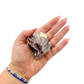 Lepidolite crystal specimen from Brazil held in hand to show scale