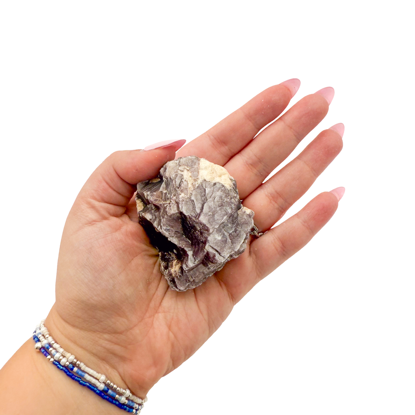 Lepidolite crystal specimen from Brazil held in hand to show scale