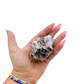 Lepidolite crystal specimen from Brazil held in hand to show scale