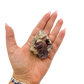 Lepidolite crystal specimen from Brazil held in hand to show scale