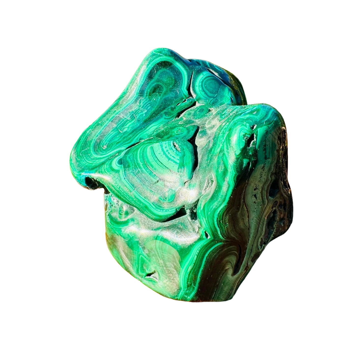Held in hand is a Malachite specimen, shown for shape and scale.