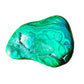 On a soft surface rests a Malachite specimen, from Haut-Katanga, Democratic Republic of the Congo, traditionally used for Manifestation, showing the wear and finish.