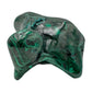 Malachite specimen turned to show a pointed knob catching the light above a flatter banded base.
