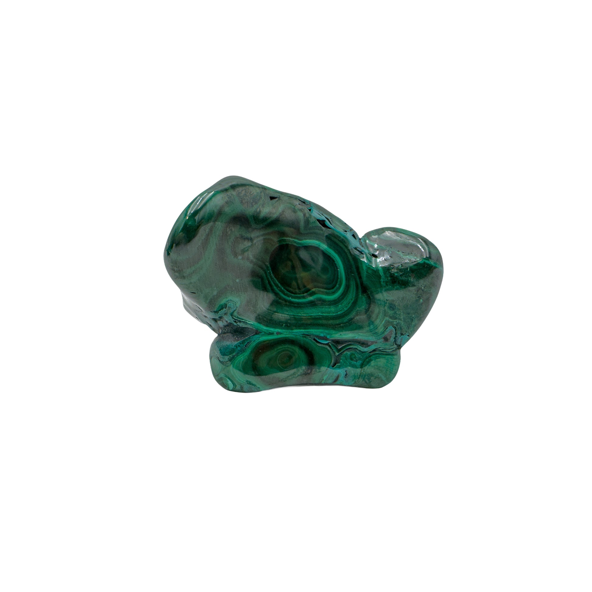 Low horizontal view of the malachite specimen, with a small rounded knob offsetting its wider base.