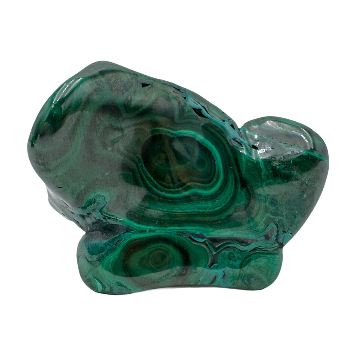 Low horizontal view of the malachite specimen, with a small rounded knob offsetting its wider base.