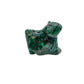 Angled view of the malachite specimen with a pointed lobe and softer light across the banded surface.