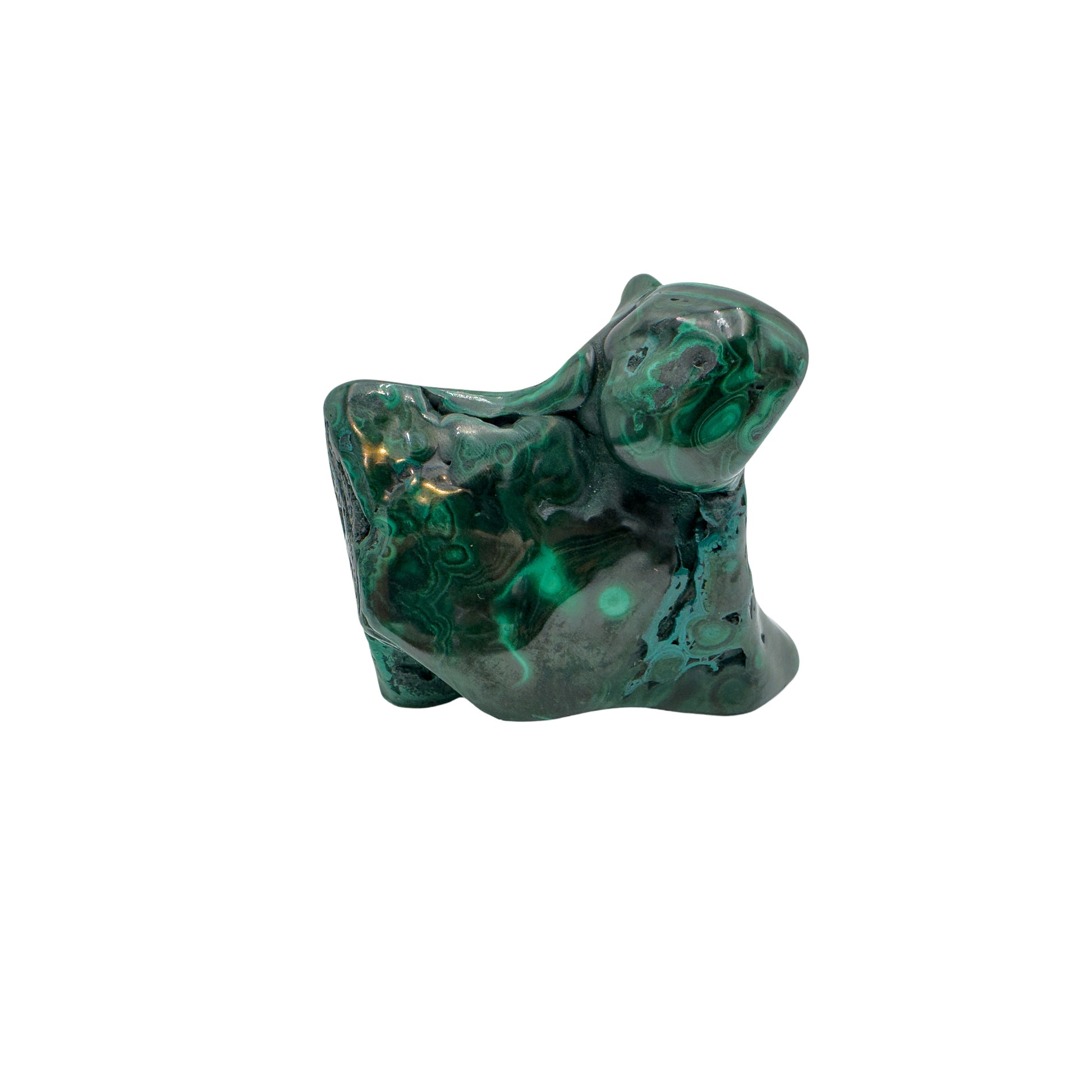 Angled view of the malachite specimen with a pointed lobe and softer light across the banded surface.