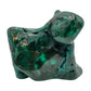 Angled view of the malachite specimen with a pointed lobe and softer light across the banded surface.
