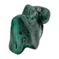 Narrow, tall view of the malachite specimen, its pointed knob rising above a compact banded body.