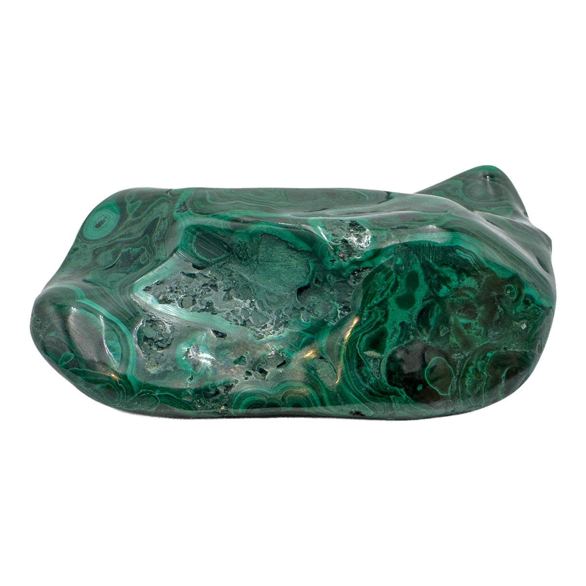 Malachite specimen viewed from a compact angle, its banded top face catching the light across a low, wide stone.