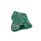 The same malachite specimen tilted upright, showing the pointed ridge along one edge of the polished face.