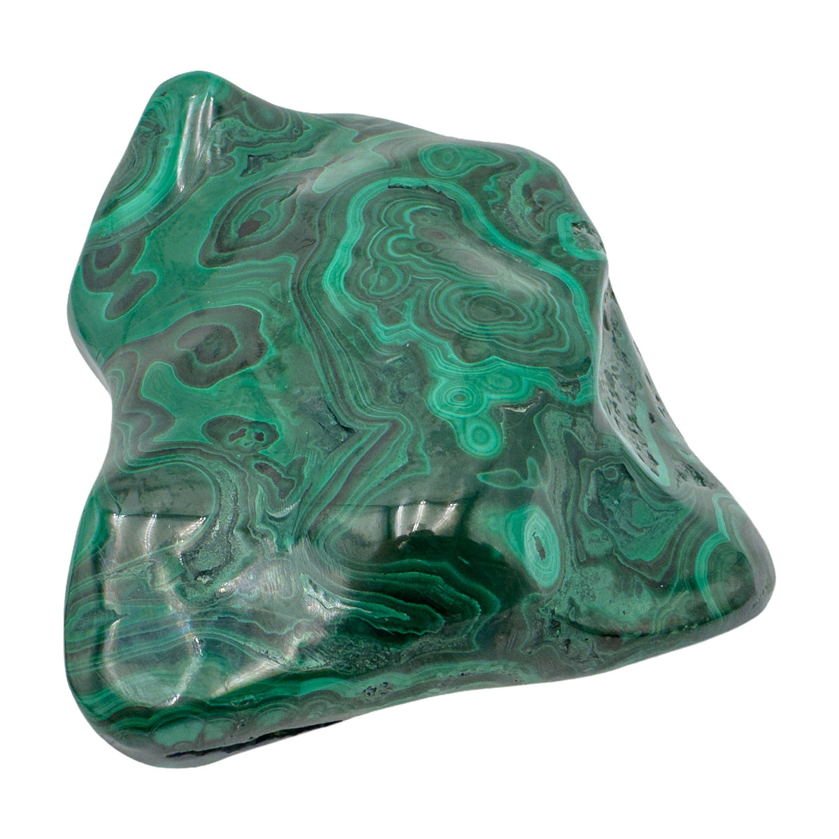 The same malachite specimen tilted upright, showing the pointed ridge along one edge of the polished face.