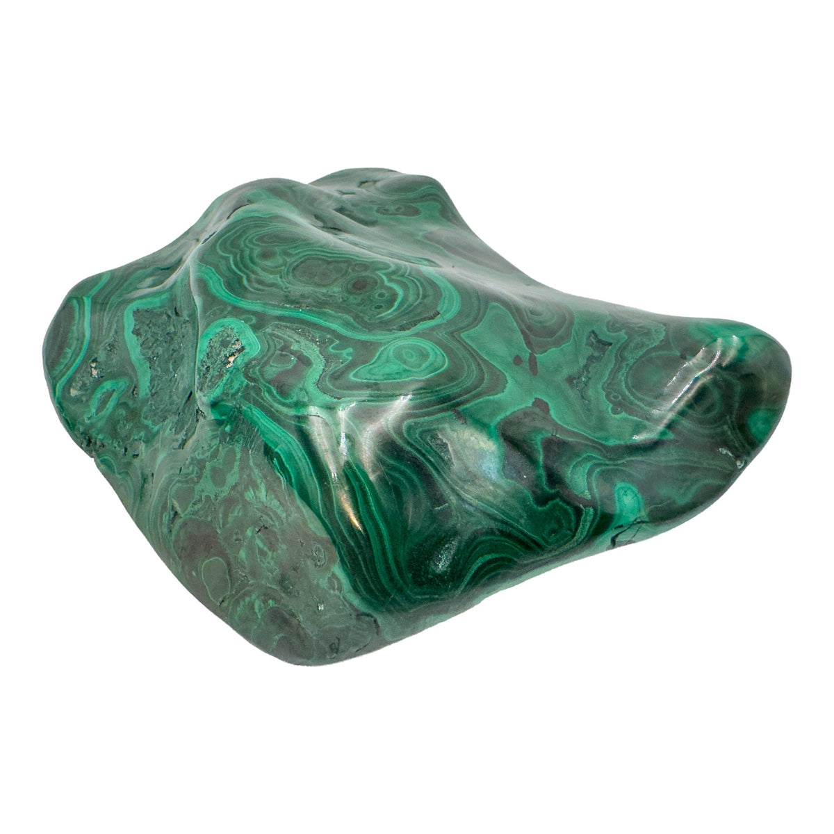 Angled view of the malachite specimen showing a cooler gray tone along the left edge of the banded face.