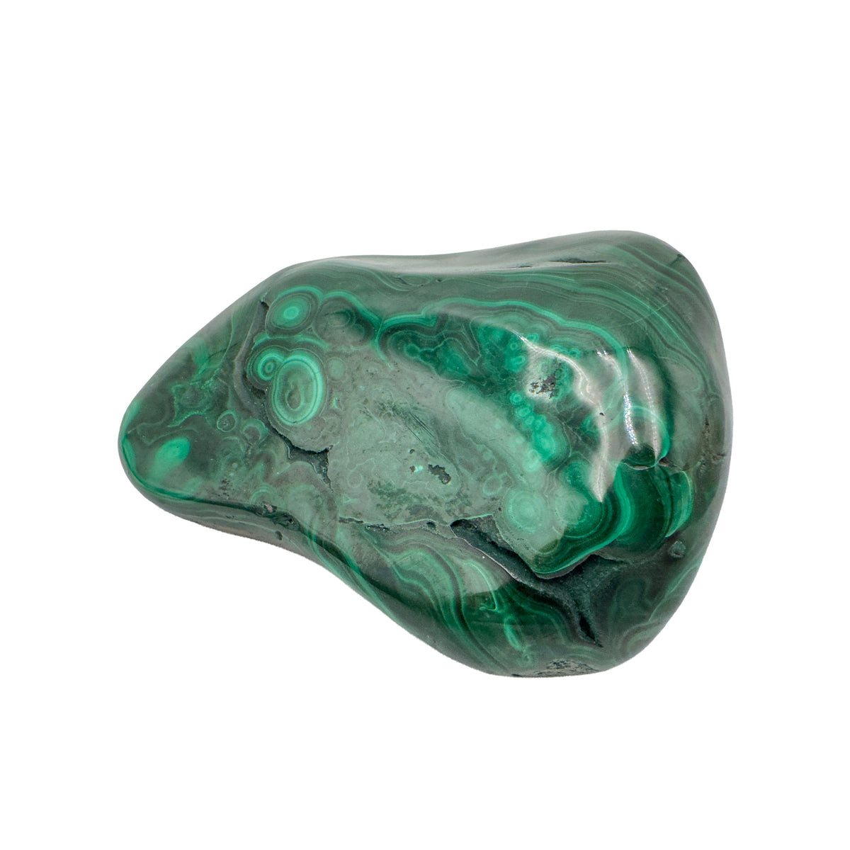Wider view of the malachite specimen, with curved layers of banding stacked across its low, elongated face.