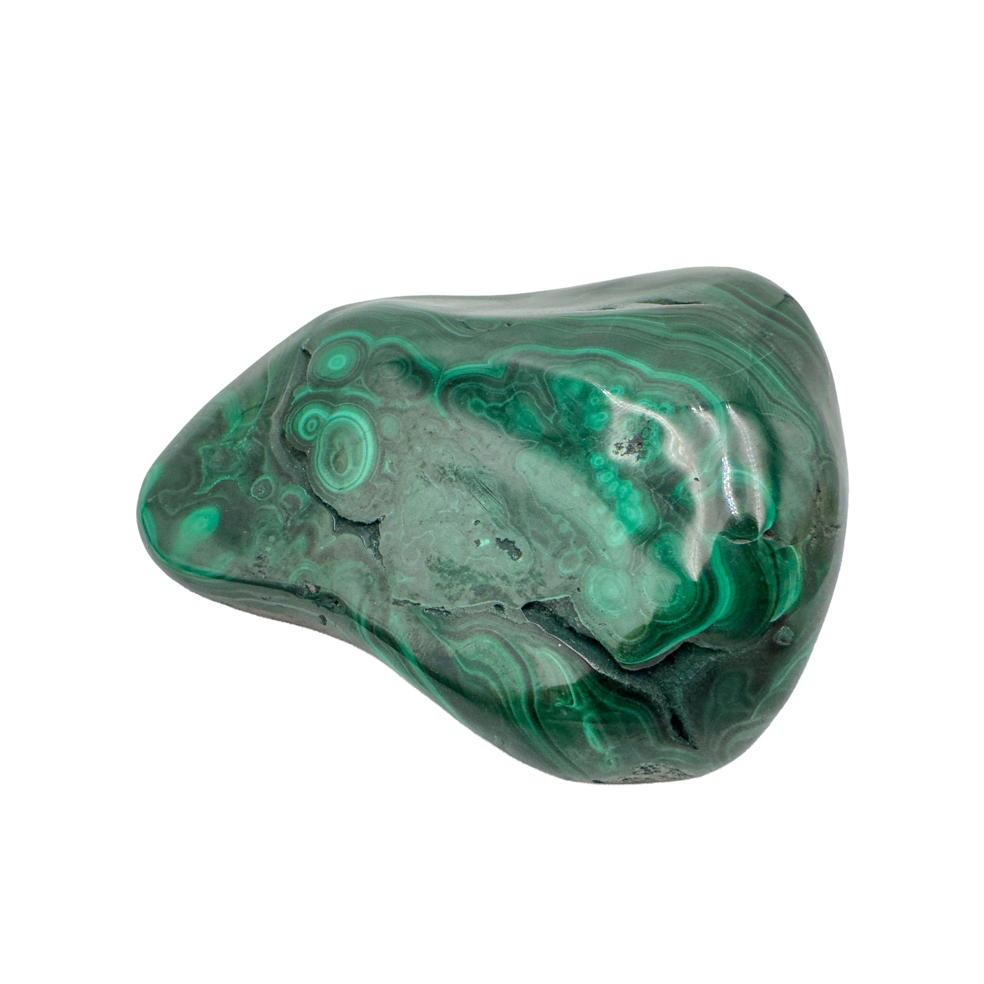 Wider view of the malachite specimen, with curved layers of banding stacked across its low, elongated face.