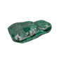 AA-grade malachite specimen from Haut-Katanga, Democratic Republic of the Congo, shown lengthwise from a low side angle across its elongated shape.