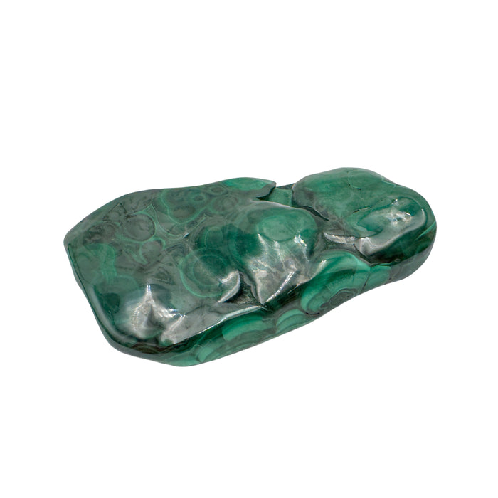 AA-grade malachite specimen from Haut-Katanga, Democratic Republic of the Congo, shown lengthwise from a low side angle across its elongated shape.