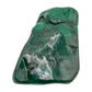 The same elongated malachite specimen stood upright, showing banding running the length of the stone.