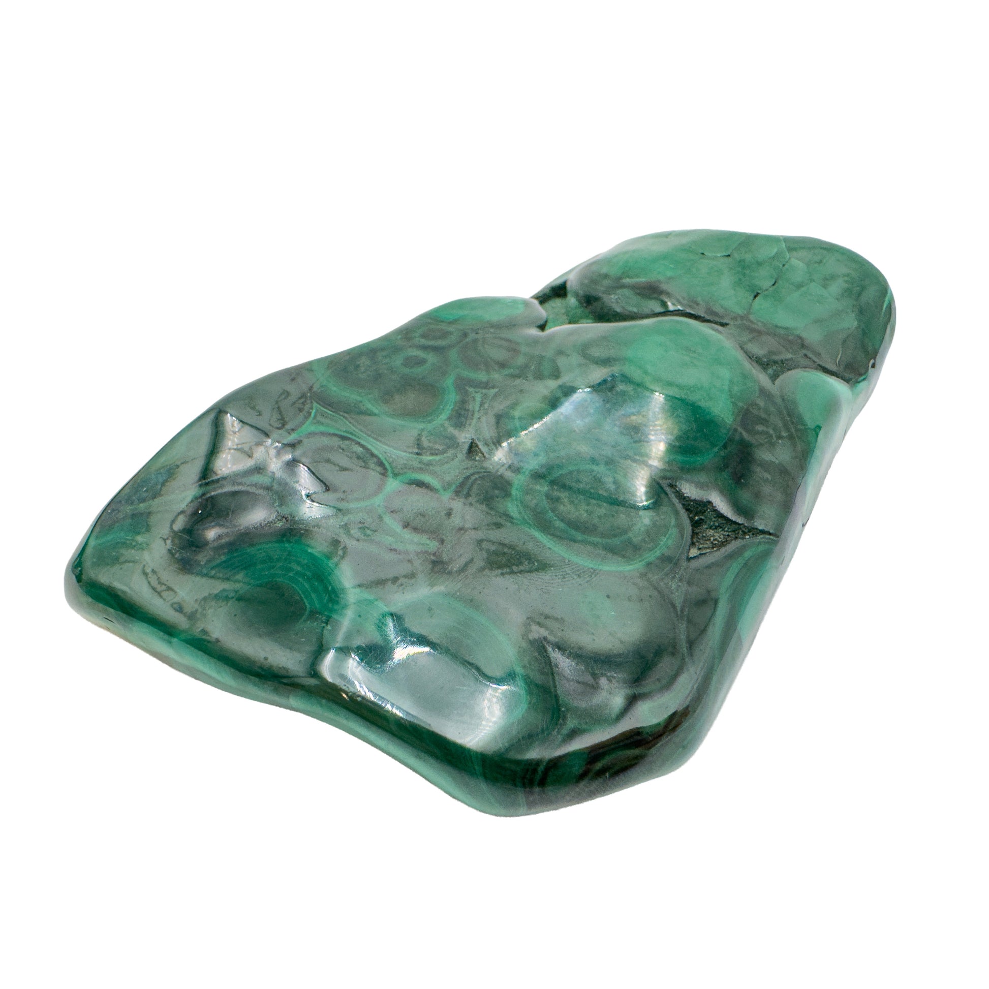 Three-quarter view of the malachite specimen with a rounded botryoidal bump and bullseye banding visible near the top edge.