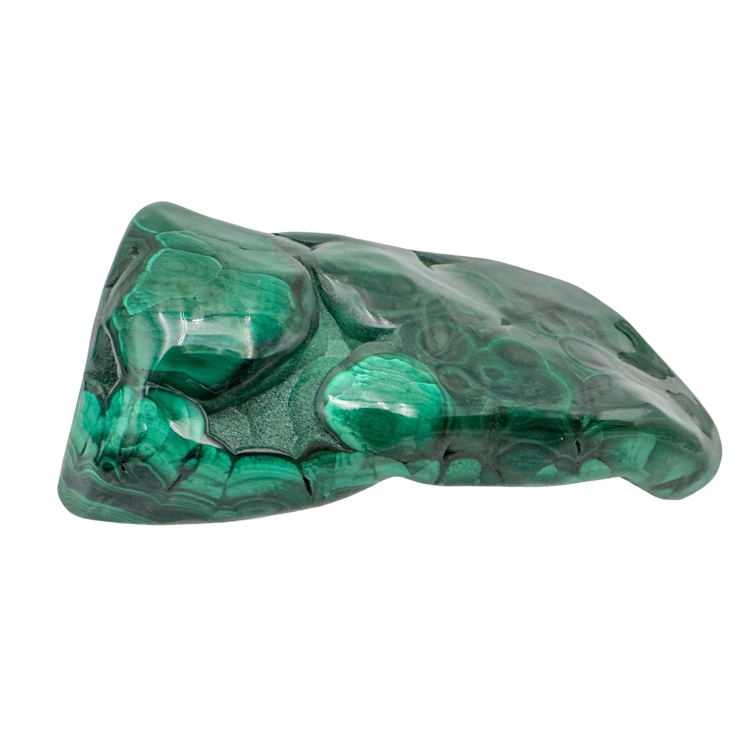 Angled side view of the malachite specimen showing a darker gray band along one edge of the stone.