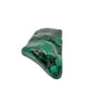 Close angled view of the malachite specimen's narrower end, tapering to a rounded point.