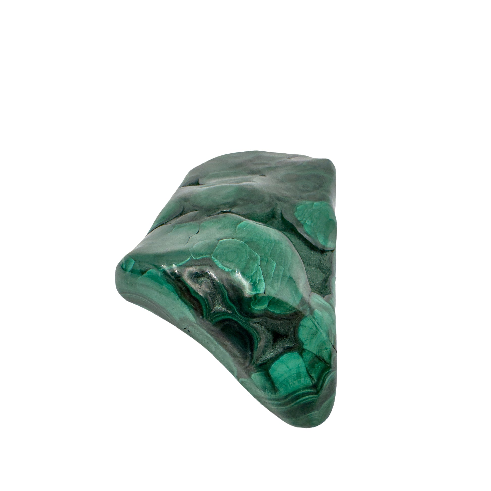 Close angled view of the malachite specimen's narrower end, tapering to a rounded point.