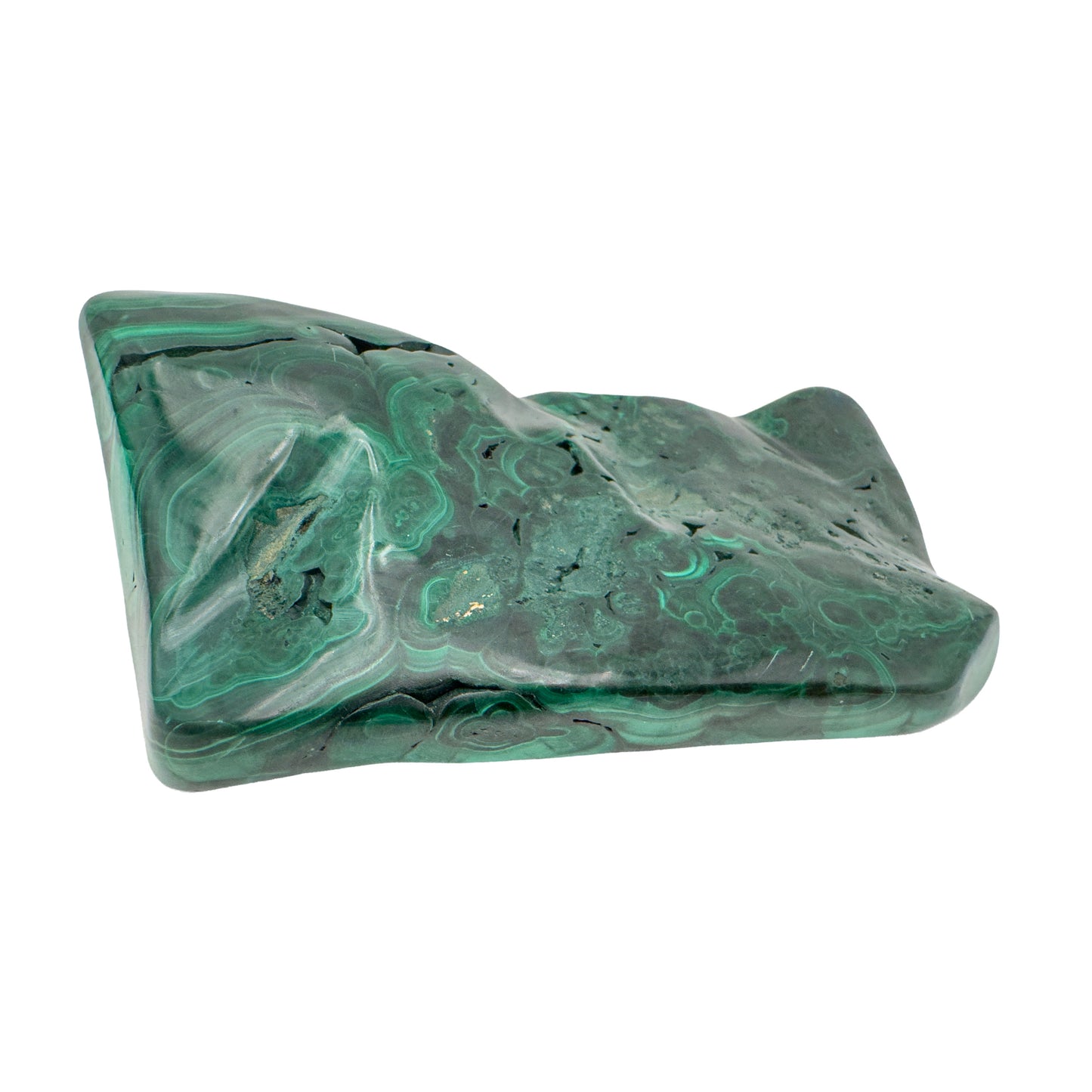 Malachite specimen photographed upright at a dramatic angle, emphasizing the elongated form and rising green banding.