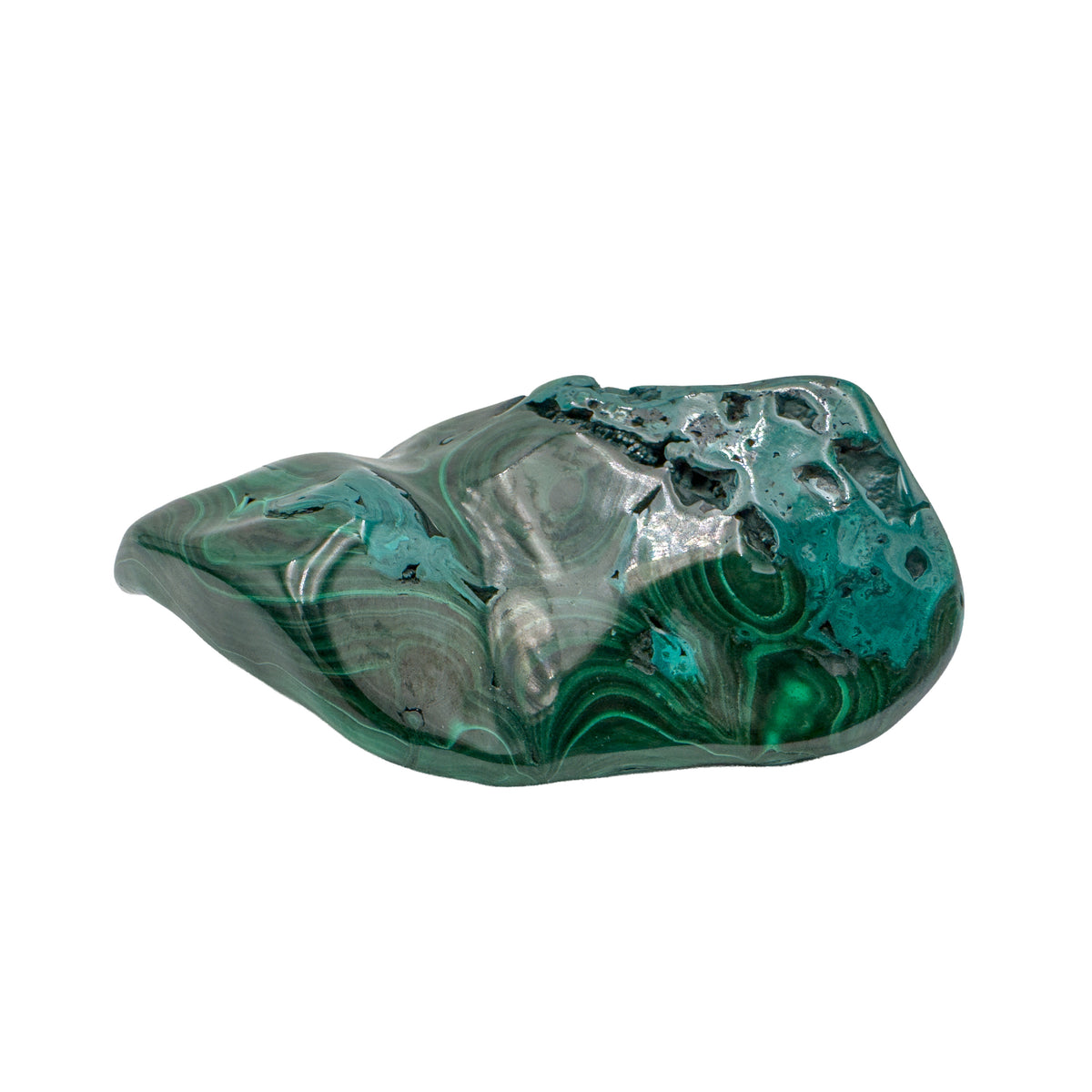 The same malachite specimen from a mirrored angle, showing concentric green rings across the lower two-thirds of the stone.